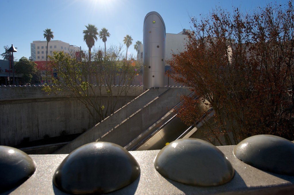 Emerging from the underground BART station, one ascends through a large round opening and greeted by the round colored spotlights from portholes of the cylindrical beacon tower